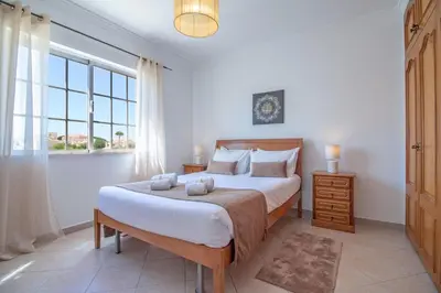 a bedroom with a large bed and a large window at Villa Azul in Guia