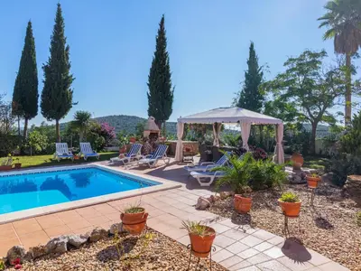 a backyard with a swimming pool and a gazebo at Villa Villa Rosa by Interhome in Loulé