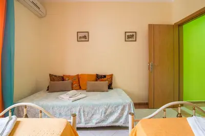 a small room with a bed with a green accent at T2 Anastácio com vista Jardim in Olhos de Água