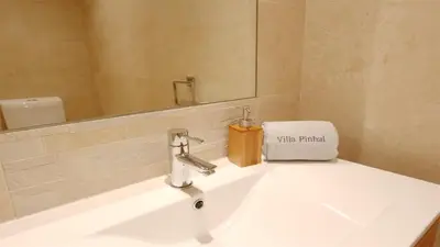 a bathroom sink with a faucet and a mirror at Villa Pinhal 213-CleverDetails- Sleeps 8, Quiet area, walking distance in Vilamoura