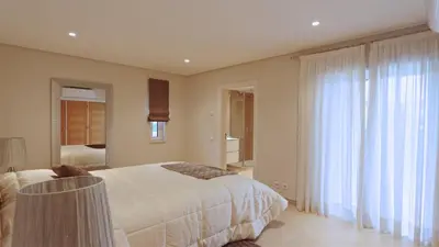 a bedroom with a bed and a large window at Villa Pinhal 213-CleverDetails- Sleeps 8, Quiet area, walking distance in Vilamoura