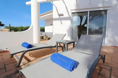 a couple of chairs sitting on a patio at Villa Pinhal 213-CleverDetails- Sleeps 8, Quiet area, walking distance in Vilamoura