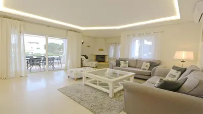 a living room with a couch and a table at Villa Pinhal 213-CleverDetails- Sleeps 8, Quiet area, walking distance in Vilamoura