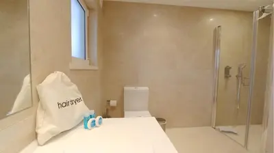 a bathroom with a toilet and a glass shower at Villa Pinhal 213-CleverDetails- Sleeps 8, Quiet area, walking distance in Vilamoura