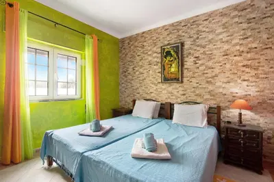a bedroom with two beds with towels on them at T2 Anastácio com vista Piscina in Olhos de Água