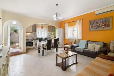 a living room with a couch and a table at T2 Anastácio com vista Piscina in Olhos de Água
