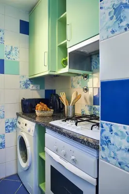a kitchen with green cabinets and a washing machine at Casas Barulho Albufeira Marina in Albufeira