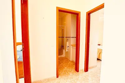 two views of a hallway with a mirror at Estrada de, Urbanizacao,edificio laranjal,apartment 18,vale carro, 8200-596 in Albufeira