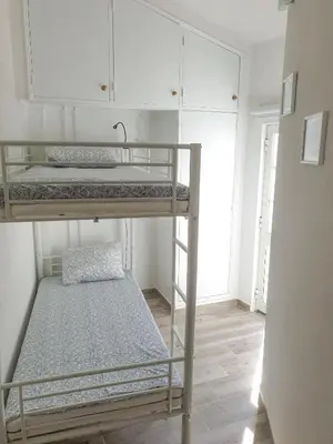 a room with two bunk beds and a sink at Casa Albufeira in Albufeira