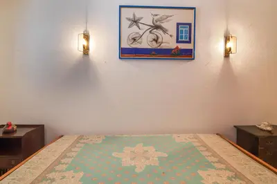 a bedroom with a bed and a picture on the wall at Apartamento Avenida da Liberdade in Albufeira
