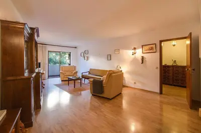 a living room with a couch and a chair at Apartamento Avenida da Liberdade in Albufeira