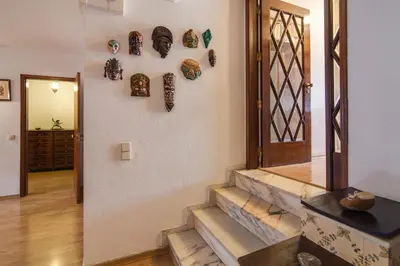 a hallway with a staircase with plates on the wall at Apartamento Avenida da Liberdade in Albufeira