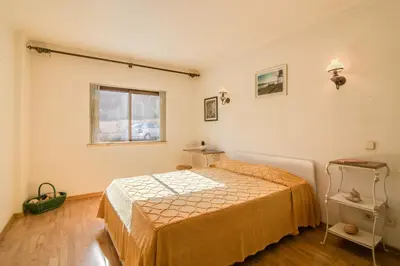 a bedroom with a bed and a window at Apartamento Avenida da Liberdade in Albufeira