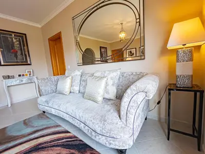 a living room with a couch and a mirror at Protea 214-CleverDetails, Located in heart of Vilamoura Sleeps 2 adults, 1child in Vilamoura