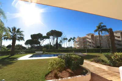 a view of a park with palm trees and a building at Protea 214-CleverDetails, Located in heart of Vilamoura Sleeps 2 adults, 1child in Vilamoura