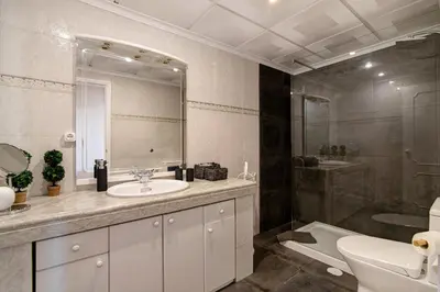 a bathroom with a sink and a toilet and a mirror at Palmeira Galé in Galé