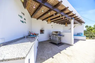 an outdoor kitchen with a counter and a stove at Private Oasis in Algarve with Pool & Fruit Garden in Loulé