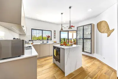 a kitchen with white counters and a large island at Private Oasis in Algarve with Pool & Fruit Garden in Loulé