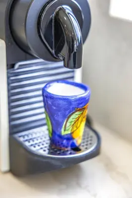 a cup is sitting on a plate under a faucet at Private Oasis in Algarve with Pool & Fruit Garden in Loulé