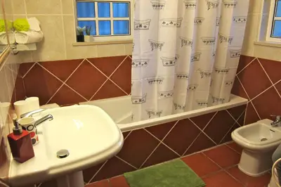 a bathroom with a sink and a shower curtain at 5 Bedroom Private Villa Tenazinha III, pool, garden, BBQ in Albufeira