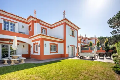a large orange and white house with a yard at GR 2 X Private Villas Private Pools - Up to 20 Guests in Albufeira