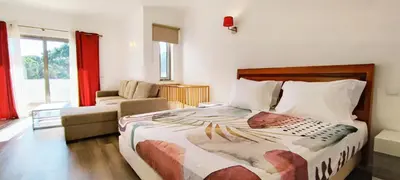 a bedroom with a bed and a couch and a chair at 6 Bedroom Private Villa Tenazinha I, with private pool in Albufeira