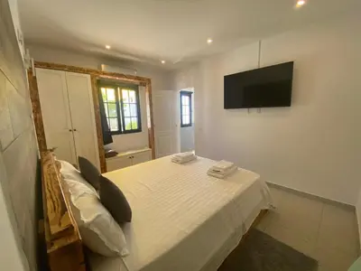 a bedroom with a bed and a flat screen tv at Quinta Verde Albufeira in Albufeira