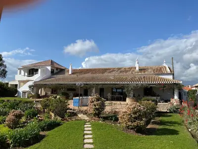 a house with a tile roof and a yard at Quinta Verde Albufeira in Albufeira