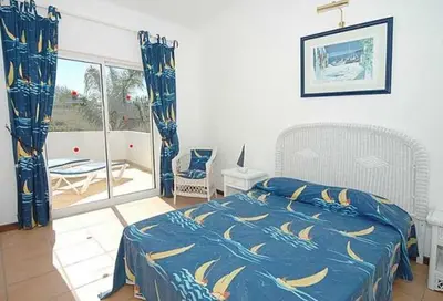 a bedroom with a bed with a blue and yellow blanket at Charming Albufeira Villa Villa Gale Gwenda 3 Bedrooms Close To Beach in Albufeira