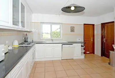 a large kitchen with white cabinets and a window at Charming Albufeira Villa Villa Gale Gwenda 3 Bedrooms Close To Beach in Albufeira