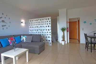 a living room with a couch and a table at AlbufeiraMar Beach Apartment in Albufeira