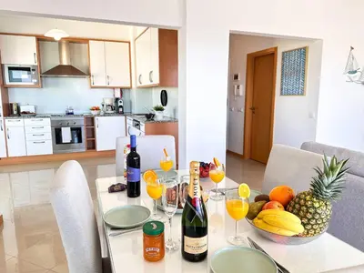 a table with glasses of wine and fruit on it at AlbufeiraOrada Gloaming by Be Cherish in Albufeira