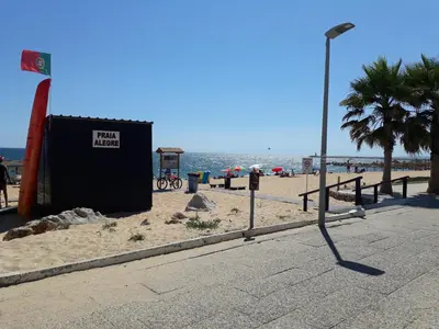 a street light on a beach next to the ocean at T1 Torre 17 Vista Cidade in Quarteira