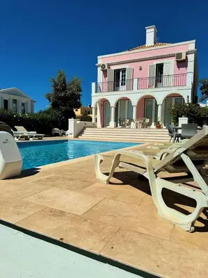 a villa with a swimming pool and a house at Elegant Vilamoura Old Town Villa Villa Camilla 6 Bedrooms Pool Table in Vilamoura