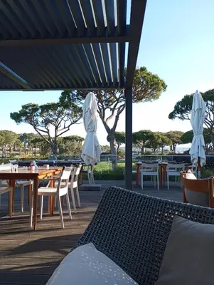 a patio with tables and chairs and umbrellas at Quinta do Lago Villa and Golf in Quinta do Lago