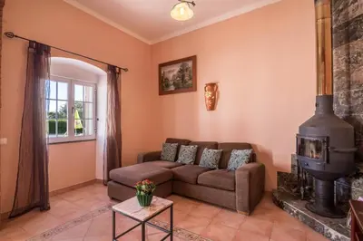 a living room with a couch and a fireplace at Casa Santa Maria in Boliqueime