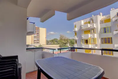 a balcony with a blue table on top of a building at AL - Apartamento 1021 Impervilla in Quarteira