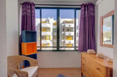 a room with a large window with purple curtains at AL - Apartamento 1021 Impervilla in Quarteira