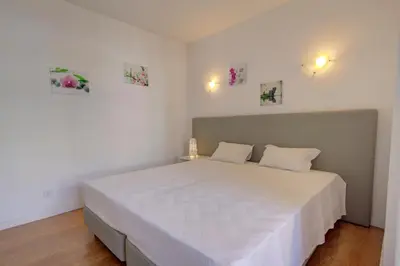 a bedroom with a large white bed with two pillows at AL - Apartamento 1021 Impervilla in Quarteira