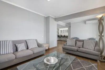 a kitchen and dining room with a table and chairs at Marina Vilamoura Penthouse Luxury in Vilamoura