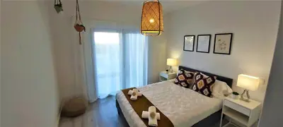 a bedroom with a large bed and a window at Albufeira beach apartment in Albufeira