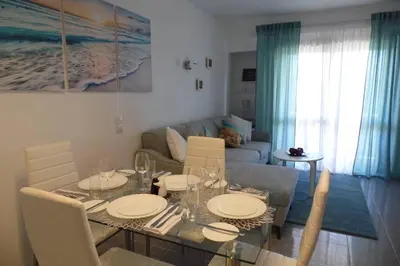 a white bedroom with a large white bed with white pillows at Happy House-fantastic holiday with all amenities in Albufeira