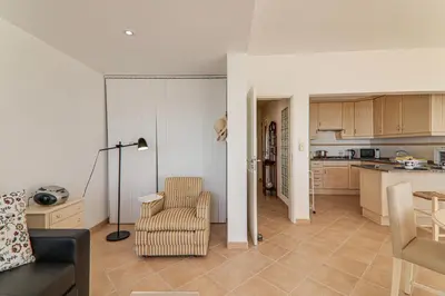 a living room with a black couch and a chair at Sail Away in Quarteira
