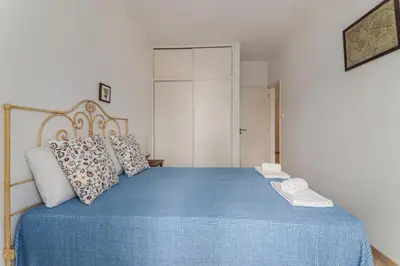 a bedroom with a blue bed with a blue blanket at Sail Away in Quarteira