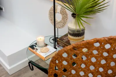 a glass table with a candle and a potted plant at M&M Home in Quinta do Lago