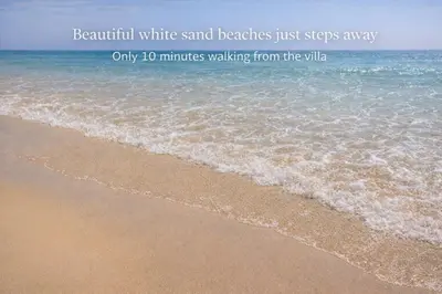a beach with the words beautiful white sand beaches just steps away at Heated Pool 6 Bedroom Private Villa in Center of Olhos de Água in Albufeira