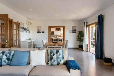 a living room with a couch and a table at Sunny House in Loulé