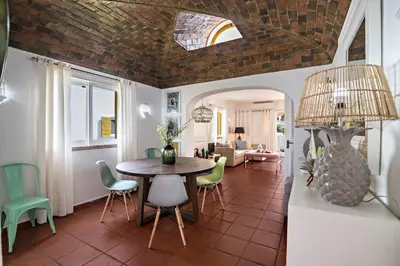 a living room with a fireplace and a tv at Casa O12 in Vilamoura