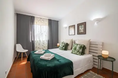 a room with a bench and antlers on the wall at Casa O12 in Vilamoura