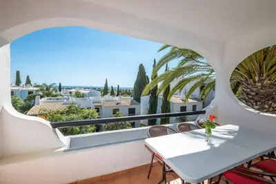 a balcony with a table and a view of the city at Carolina Sea Apartment in Albufeira